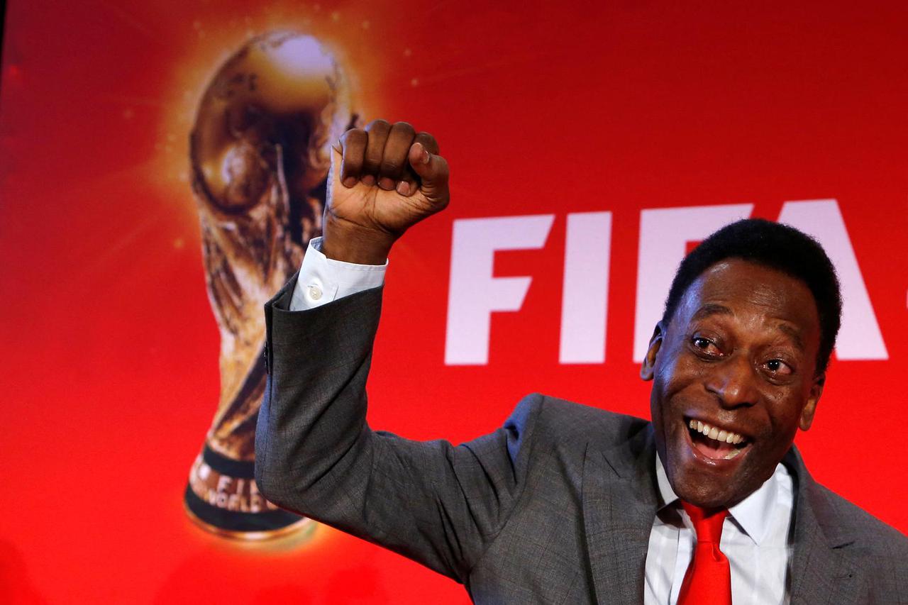 FILE PHOTO: Brazilian soccer legend Pele reacts as he poses after a news conference to present the FiFA World Cup global "Trophy Tour" in Paris