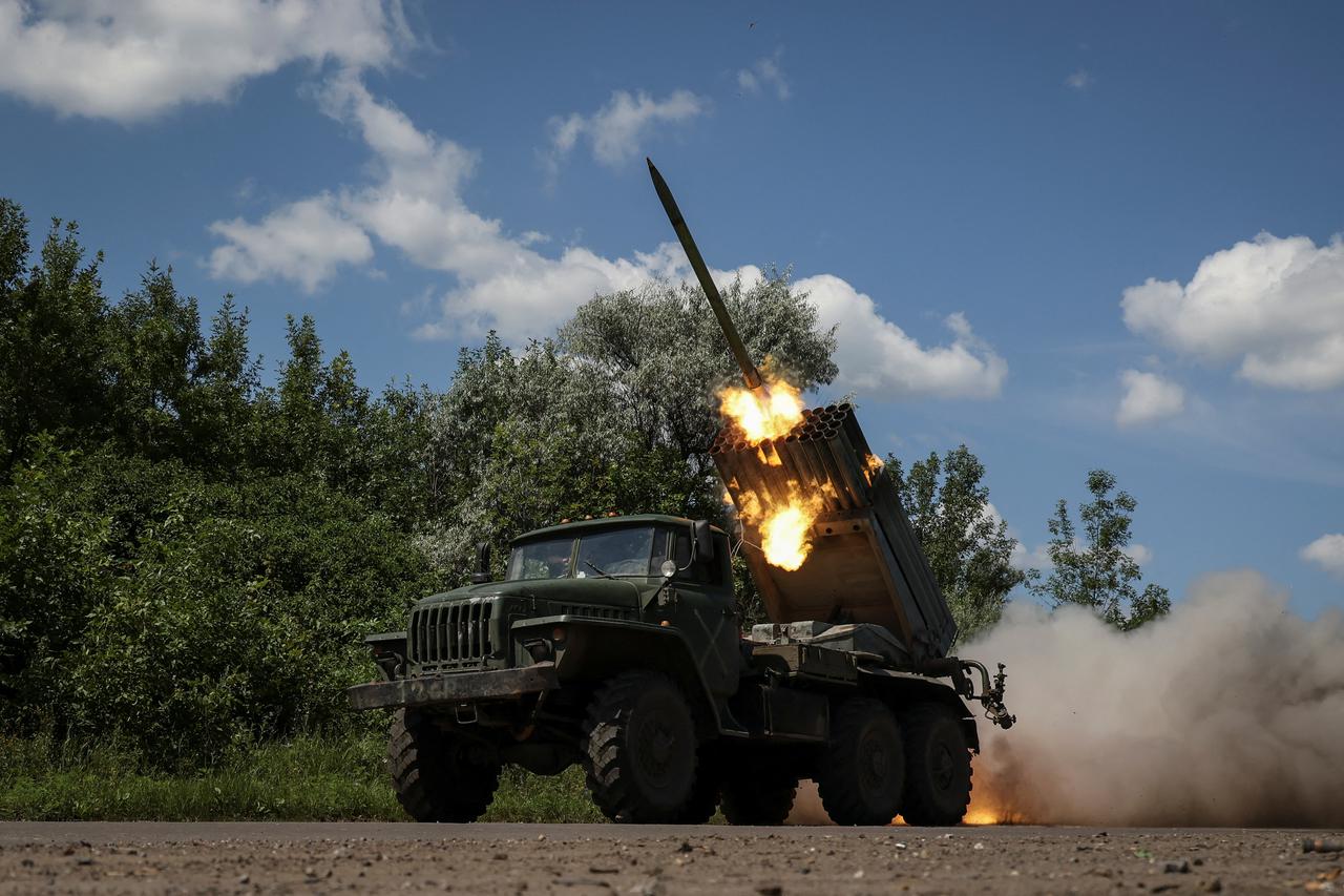 Ukrainian servicemen fire a BM-21 Grad multiple launch rocket system towards Russian troops in Donetsk region