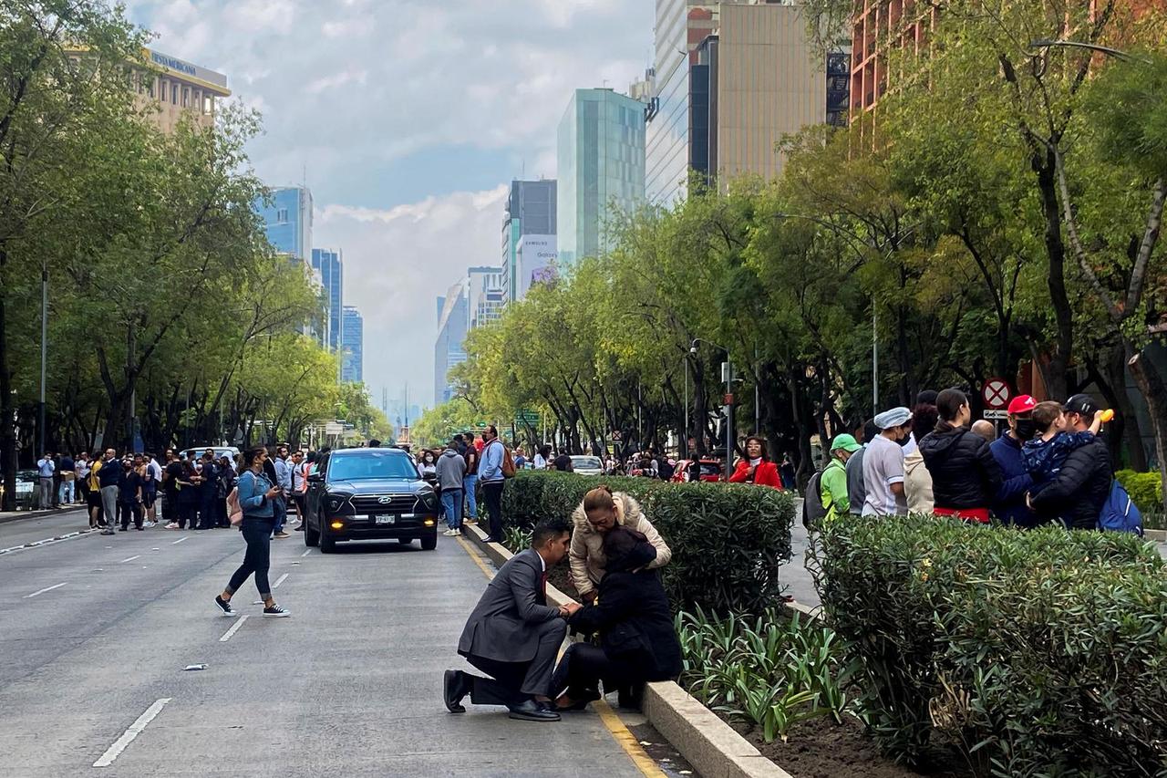 People react during a quake in Mexico City