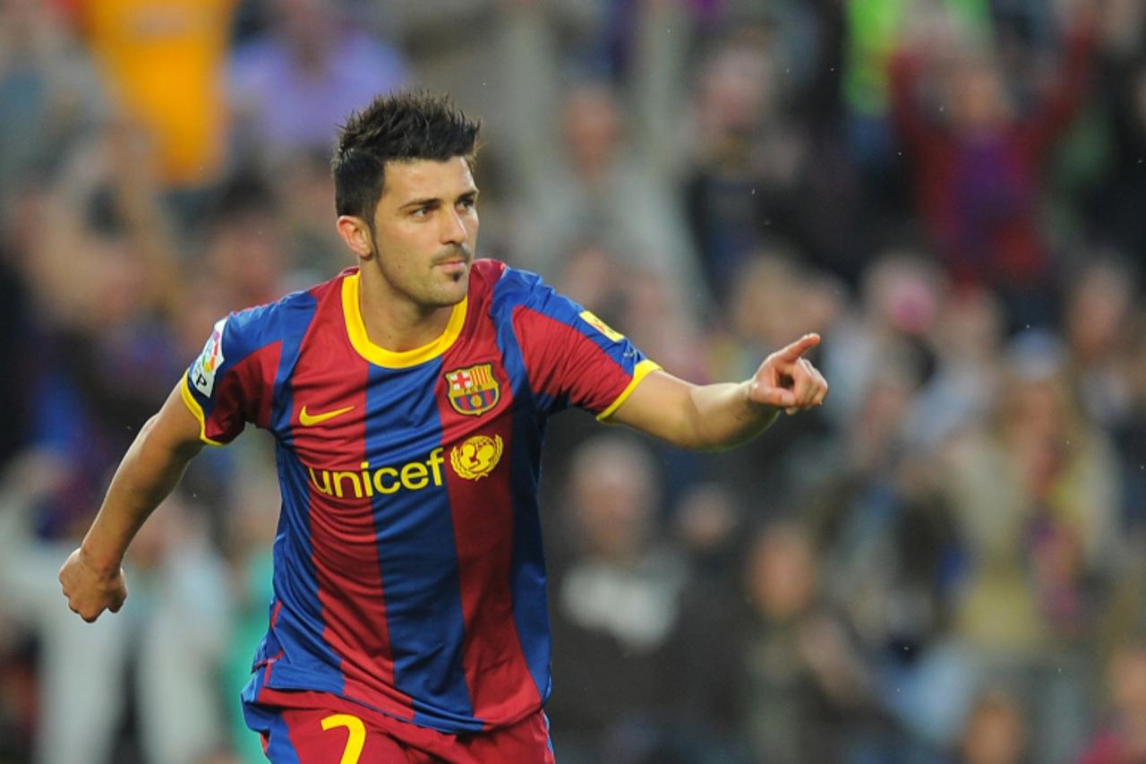 'Barcelona\'s forward David Villa celebrates after scoring a goal during the Spanish League football match FC Barcelona vs Osasuna on April 23, 2011 at Camp Nou stadium in Barcelona. AFP PHOTO/ LLUIS 