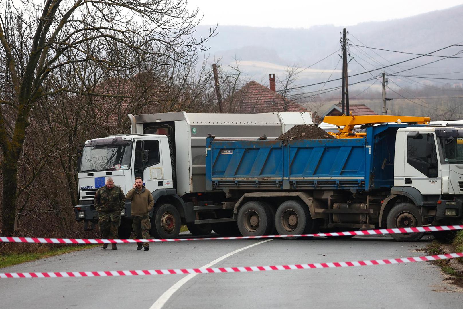 German soldiers that are part of NATO peacekeepers mission in Kosovo walk near a roadblock set up by local Serbs, in Rudare, near the northern part of the ethnically-divided town of Mitrovica, Kosovo, December 12, 2022. REUTERS/Florion Goga Photo: Florion Goga/REUTERS