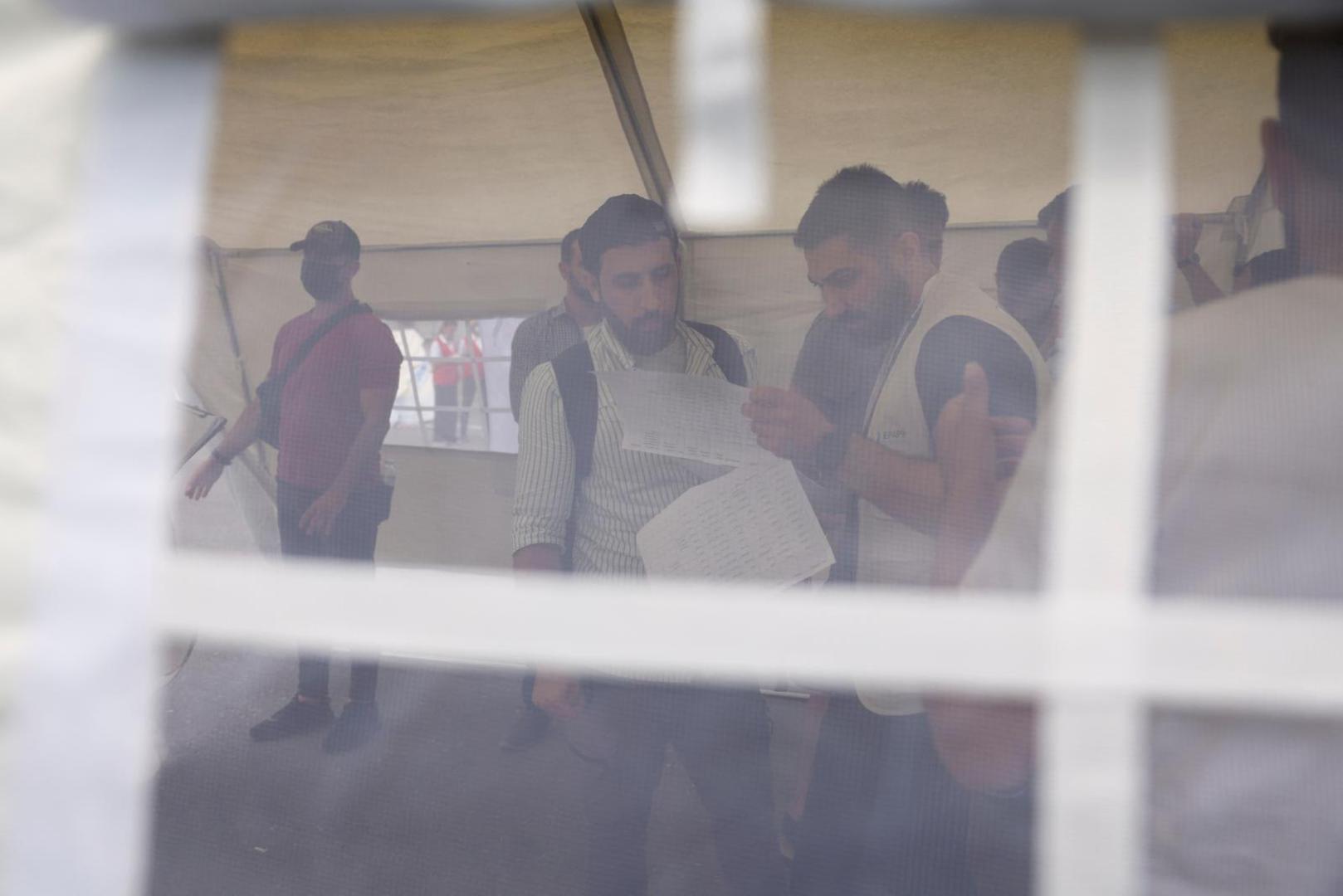 Syrian Kassam Abozeed, 34, who says his wife Israa and brother-in-law were onboard a boat with migrants that capsized at open sea off Greece, speaks to an official at the port of Kalamata, Greece, June 15, 2023. REUTERS/Stelios Misinas Photo: STELIOS MISINAS/REUTERS