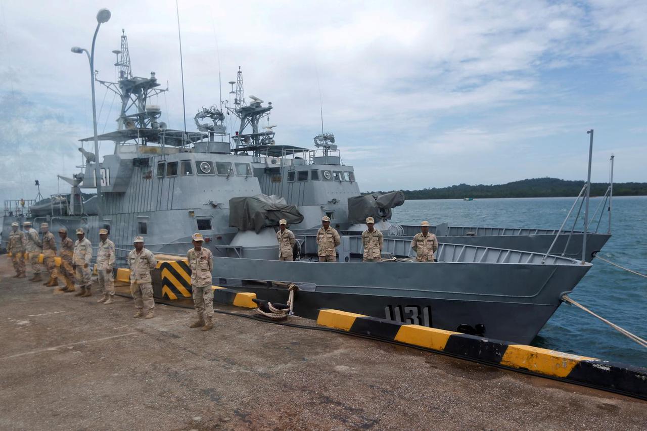 FILE PHOTO: Sailors stand guard near petrol boats at the Cambodian Ream Naval Base in Sihanoukville