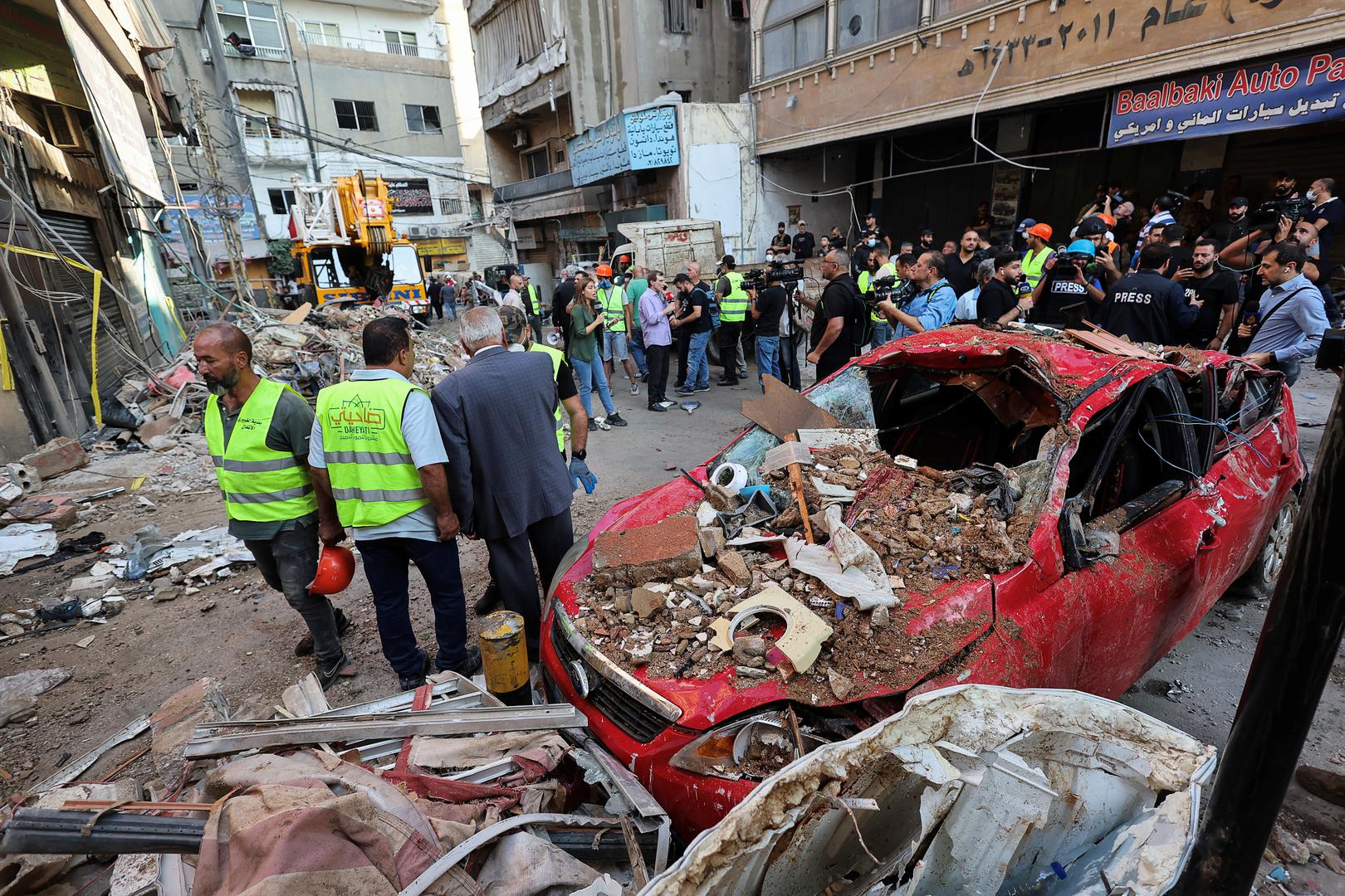 People stand next to a destroyed car, at the site of an Israeli strike in Beirut's southern suburbs, Lebanon September 24, 2024. REUTERS/Amr Abdallah Dalsh Photo: AMR ABDALLAH DALSH/REUTERS