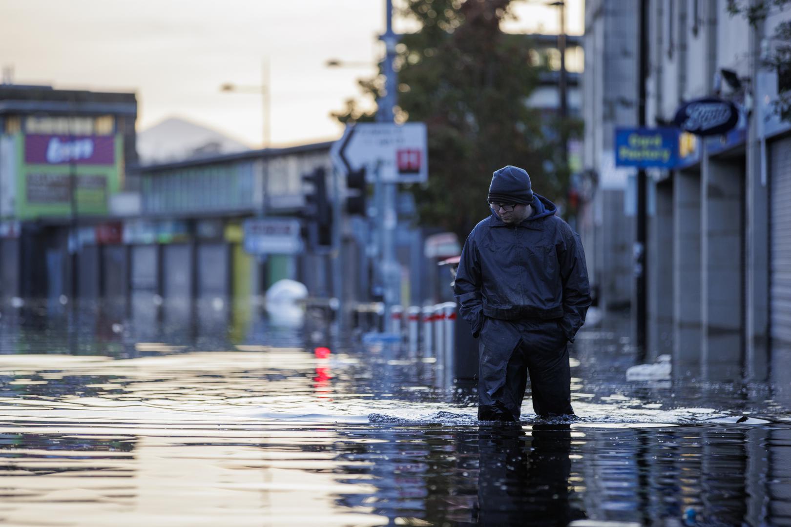 Michael McShane walks through flood water on Market Street in Downpatrick, Northern Ireland. Some rivers in Northern Ireland reached record high levels following several days of heavy rain. Picture date: Thursday November 2, 2023. Photo: Liam McBurney/PRESS ASSOCIATION