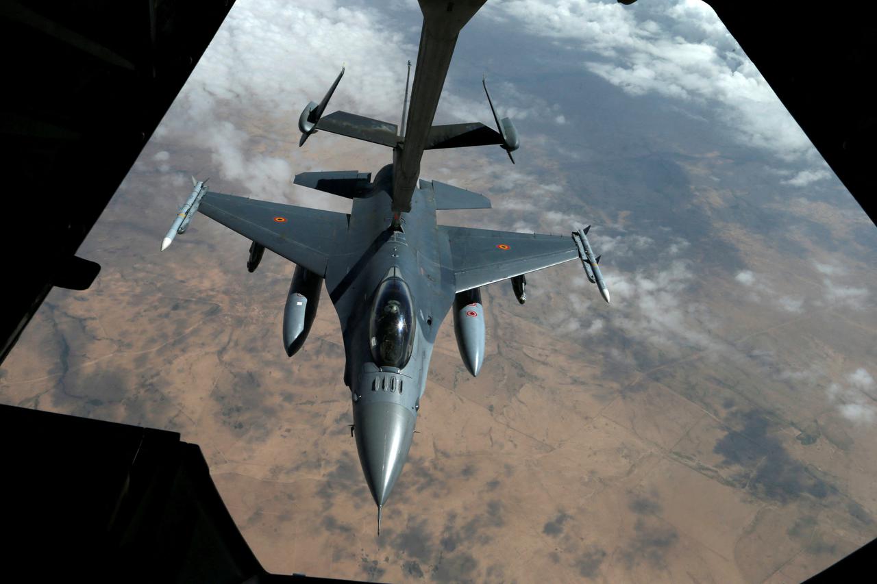FILE PHOTO: US Air Force F-16 receives fuel from fuel boom suspended from US Air Force KC-10 Extender during mid-air refueling support to Operation Inherent Resolve over Iraq and Syria air space