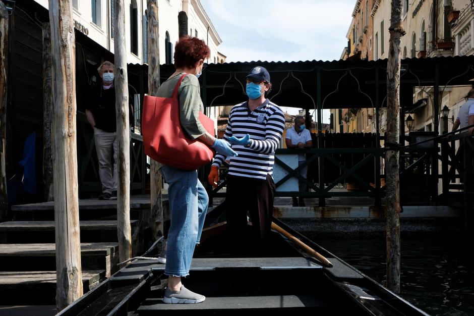 Gondoliers resume their service on the Grand Canal as Italy eases some more of the lockdown measures put in place during the coronavirus disease (COVID-19) outbreak, in Venice