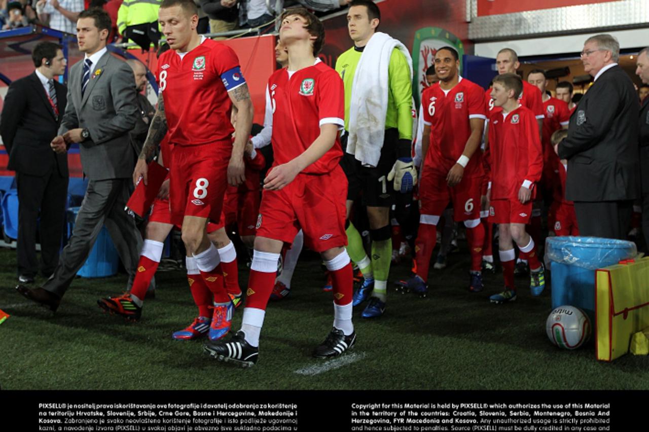 'Wales\' captain Craig Bellamy leads out his team alongside Gary Speed\'s sons Ed and TomPhoto: Press Association/PIXSELL'