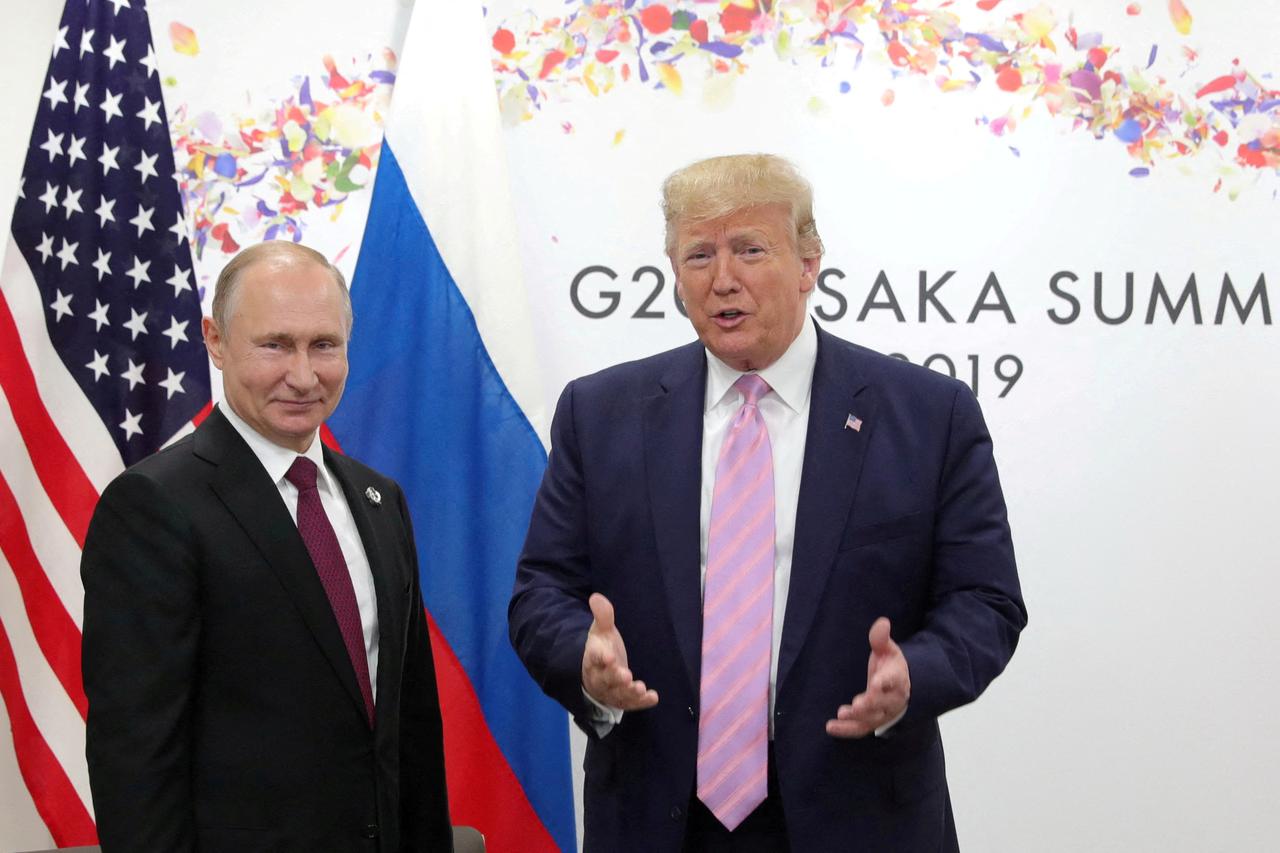 FILE PHOTO: Russia's President Vladimir Putin and U.S. President Donald Trump attend a meeting on the sidelines of the G20 summit in Osaka