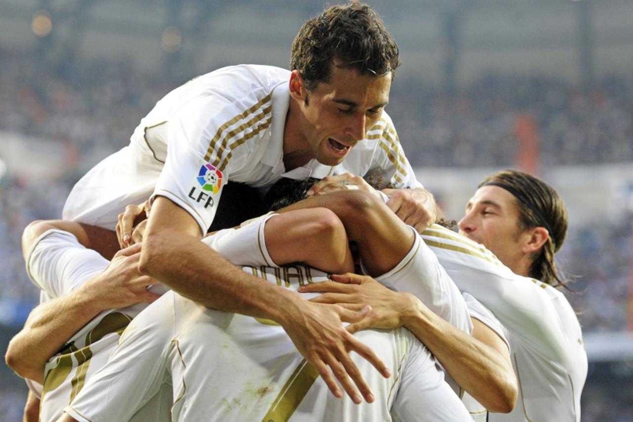 'Real Madrid players celebrate after Real Madrid\'s Argentinian forward Gonzalo Higuain scored their first goal during the Spanish League football match Real Madrid against Betis at the Santiago Berna