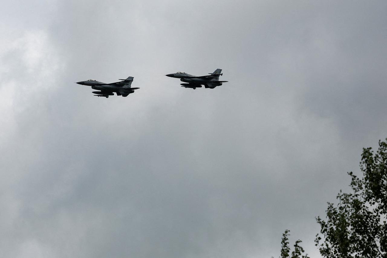 FILE PHOTO: Ukrainian F-16 fighting aircrafts are seen in the air during marking the Day of the Ukrainian Air Forces in an undisclosed location in Ukraine