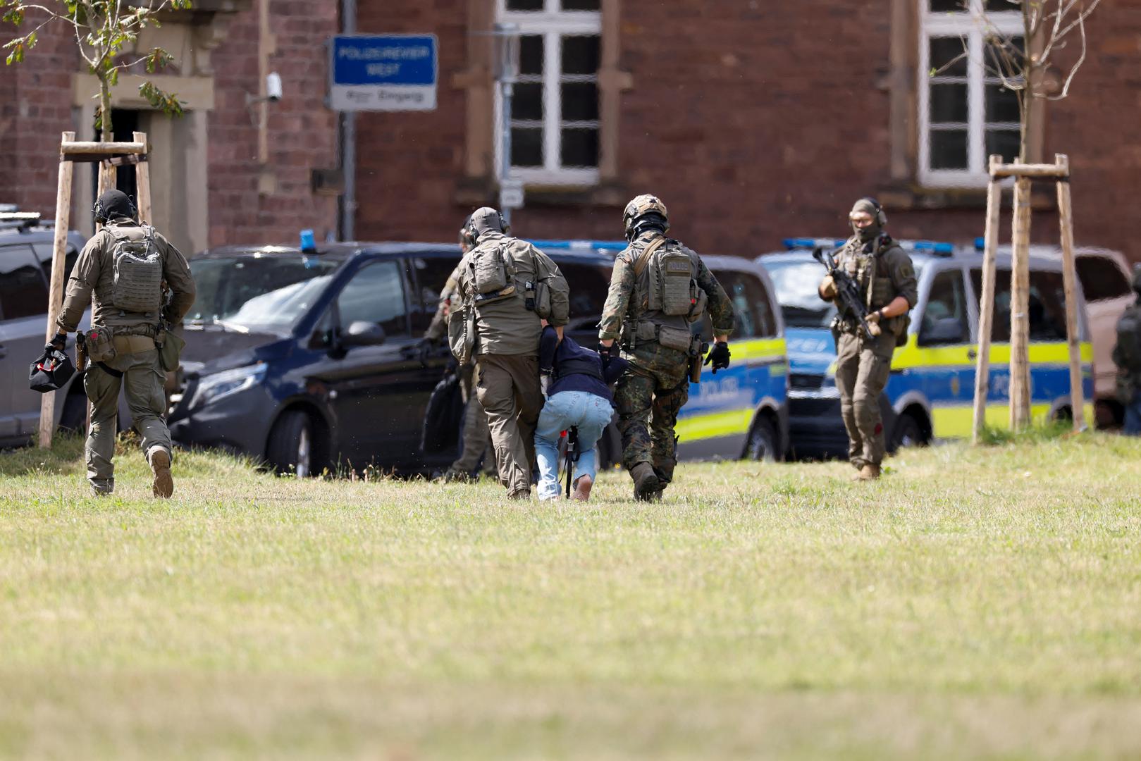 A 26-year-old Syrian man, who is the suspect in custody for a stabbing rampage in the western German city of Solingen in which several individuals were killed, is escorted by police on his way to the Federal Public Prosecutor in Karlsruhe, Germany, August 25, 2024. REUTERS/Heiko Becker Photo: Heiko Becker/REUTERS