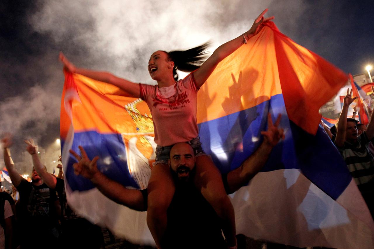 Pro-Serb opposition supporters celebrate in front of the Cathedral of the Resurrection of Christ in Podgorica