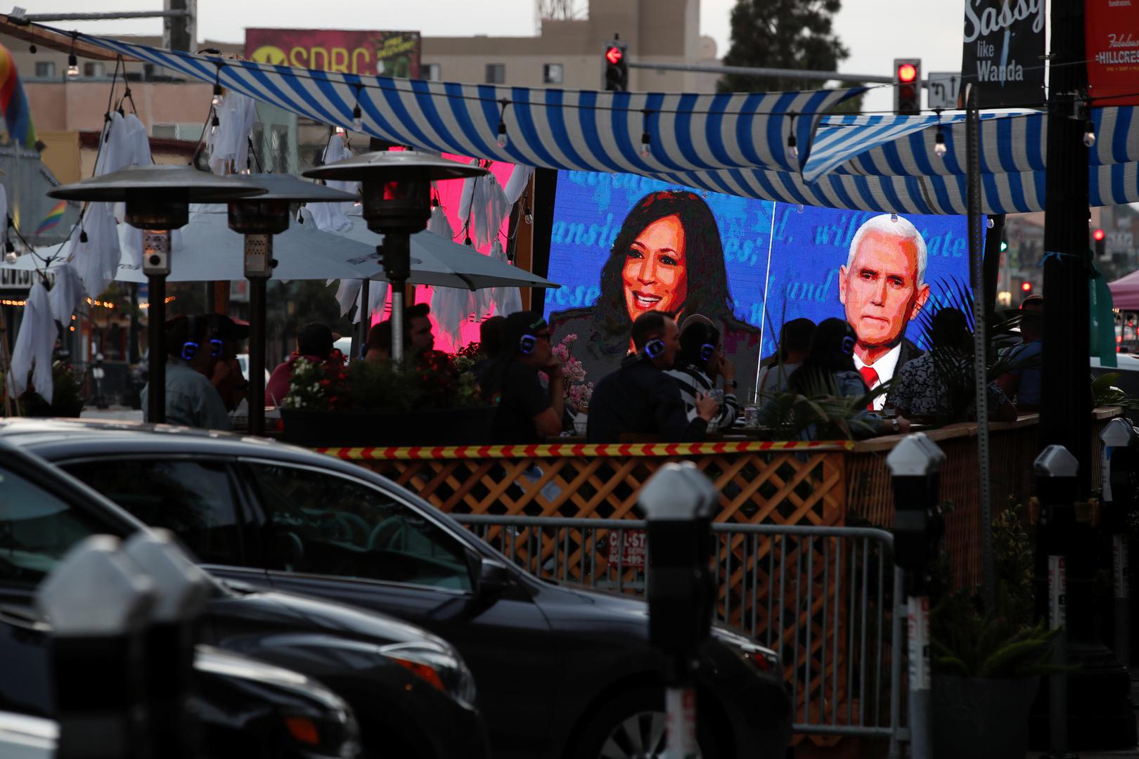 People watch the debate between U.S. Vice President Mike Pence and Democratic vice-presidential nominee Kamala Harris outside a tavern in San Diego People watch the debate between U.S. Vice President Mike Pence and Democratic vice-presidential nominee Kamala Harris outside a tavern in San Diego, California, U.S., October 7, 2020. REUTERS/ Mike Blake MIKE BLAKE