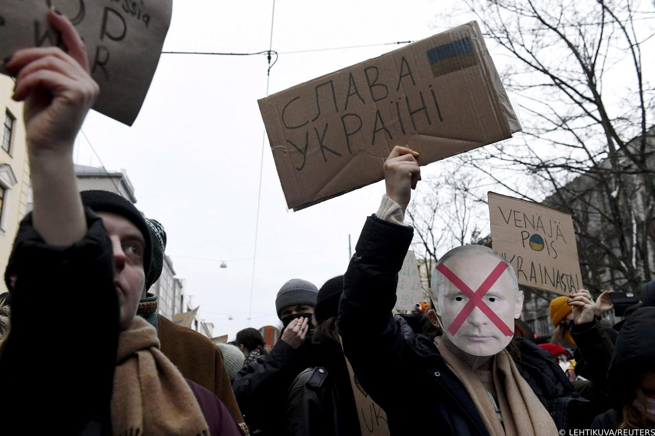 People hold a demonstration against Russia's invasion of Ukraine in front of the Russian embassy in Helsinki