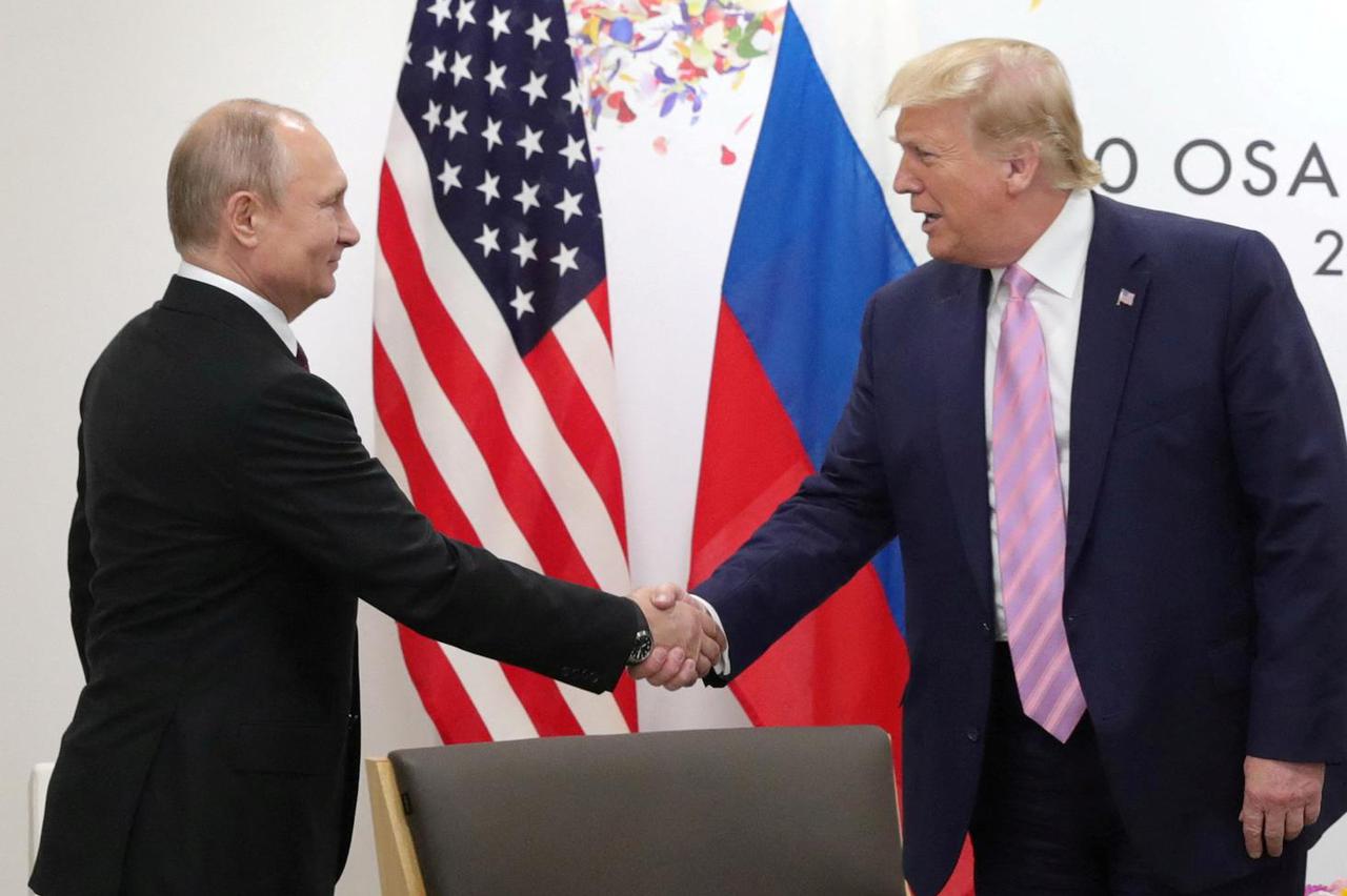 FILE PHOTO: Russia's President Vladimir Putin and U.S. President Donald Trump attend a meeting on the sidelines of the G20 summit in Osaka