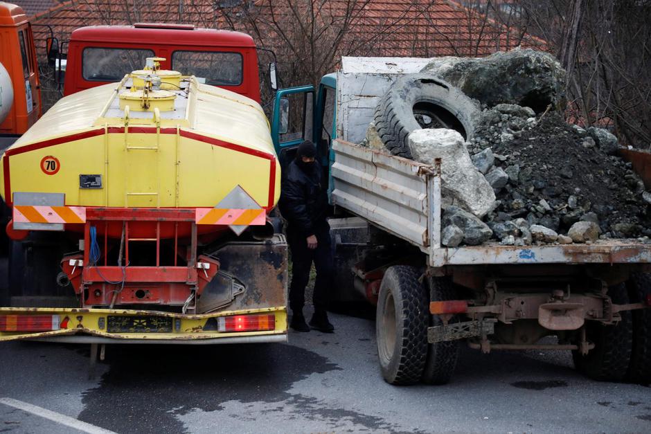 Local Serbs prepare to remove barricades at a roadblock in Rudare