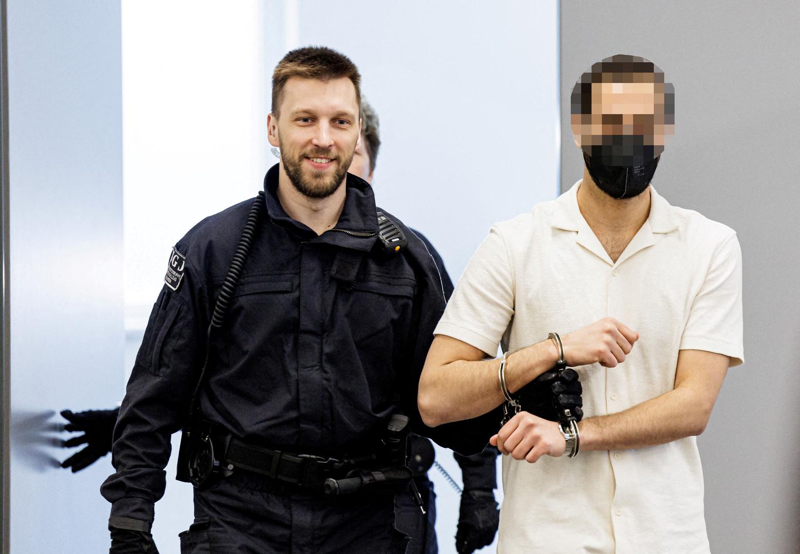 Defendant Mohamed R. is led in handcuffs by judicial officers into the courtroom of the Higher Regional Court prior to a hearing in the trial over a November 2019 jewellery heist on the Green Vault (Gruenes Gewoelbe) museum in Dresden's Royal Palace, in Dresden, Germany, March 20, 2023. Jens Schlueter/Pool via REUTERS IMAGE PIXELLATED AT SOURCE. GERMAN COURT REQUESTS THAT THE FACE OF THE DEFENDANT MUST BE MADE UNRECOGNISABLE REFILE - CORRECTING NAME Photo: POOL/REUTERS