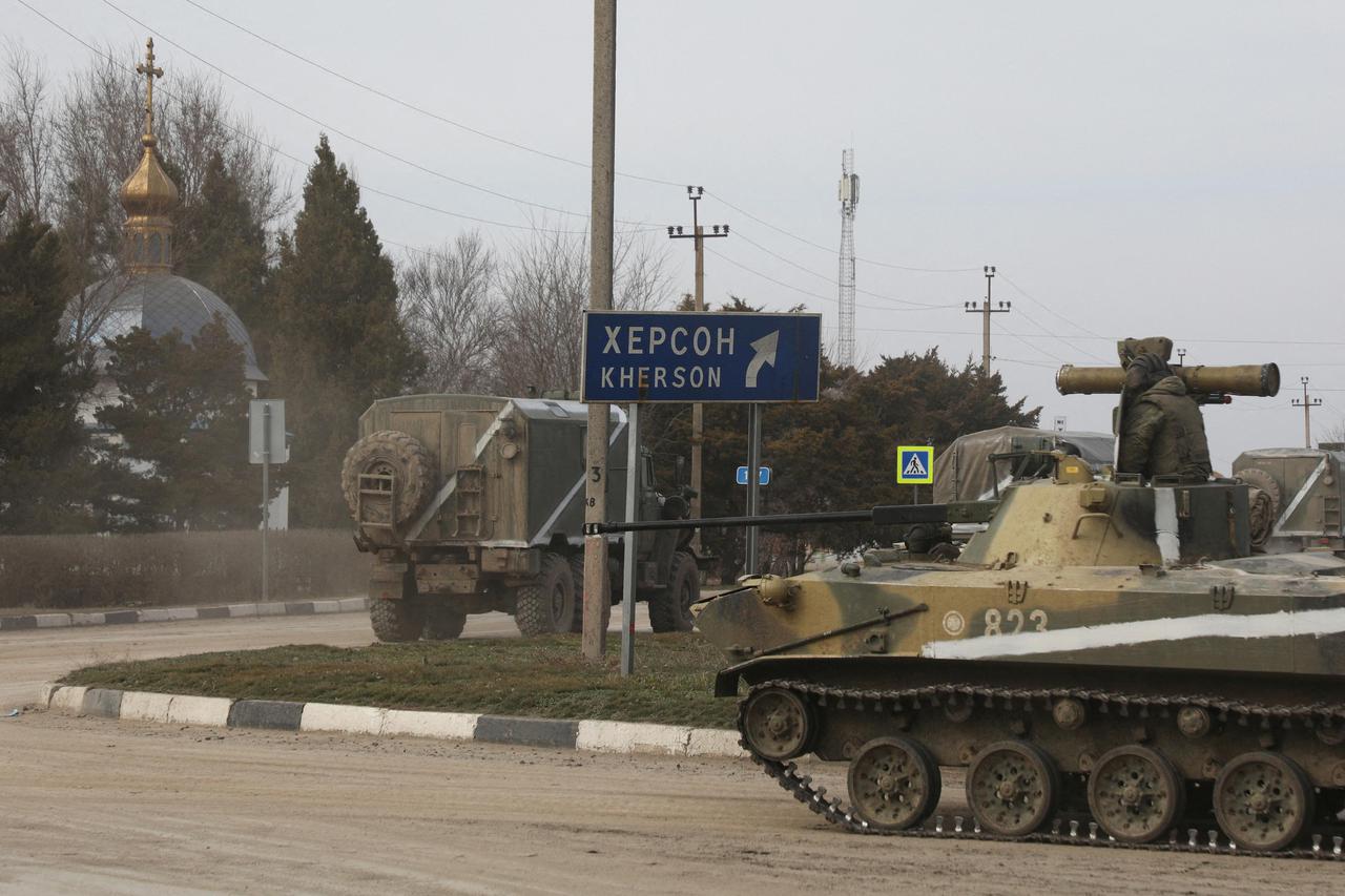 Russian Army military vehicles drive along a street in Armyansk