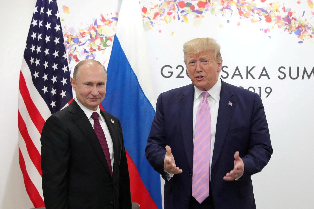 FILE PHOTO: Russia's President Vladimir Putin and U.S. President Donald Trump attend a meeting on the sidelines of the G20 summit in Osaka