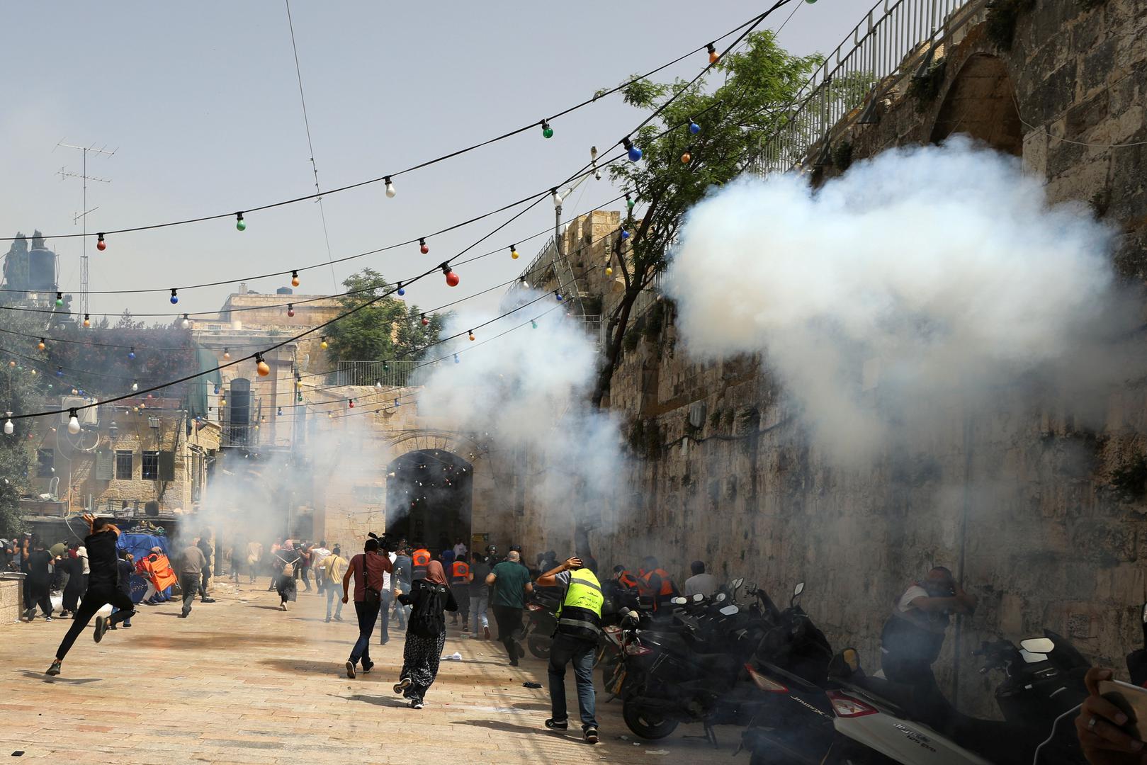 Israeli police clash with Palestinians at the compound that houses Al-Aqsa Mosque in Jerusalem Palestinians run away as Israeli police fire a stun grenade during clashes at the compound that houses Al-Aqsa Mosque, known to Muslims as Noble Sanctuary and to Jews as Temple Mount, in Jerusalem's Old City, May 10, 2021. REUTERS/Ammar Awad AMMAR AWAD