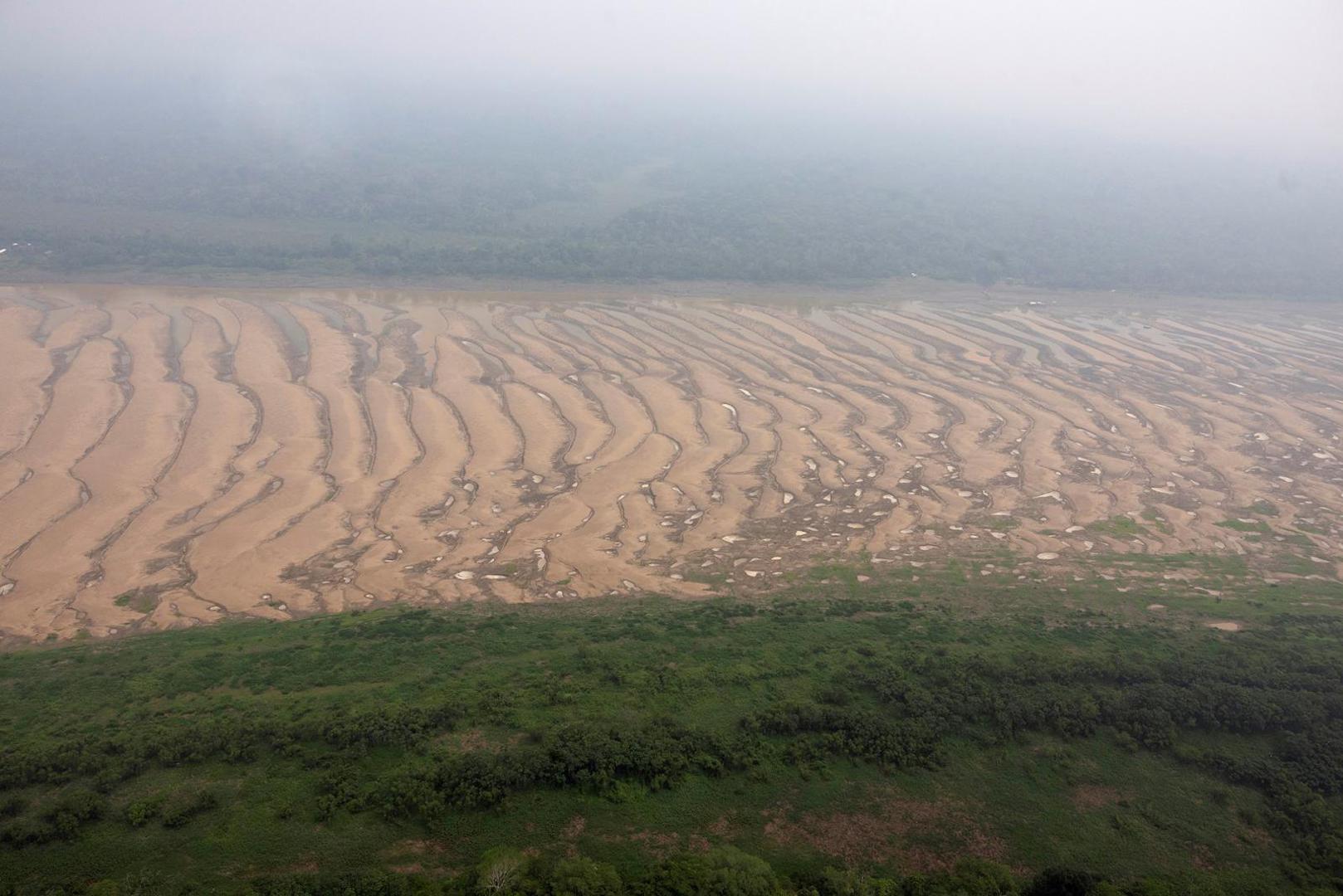 The Solimoes River, one of the largest tributaries of the Amazon River, is seen during a Greenpeace flyover to inspect what the National Center for Monitoring and Early Warning of Natural Disasters (Cemaden) says is the most intense and widespread drought Brazil has experienced since records began in 1950, near Tefe, Amazonas state, Brazil September 17, 2024. REUTERS/Jorge Silva Photo: JORGE SILVA/REUTERS