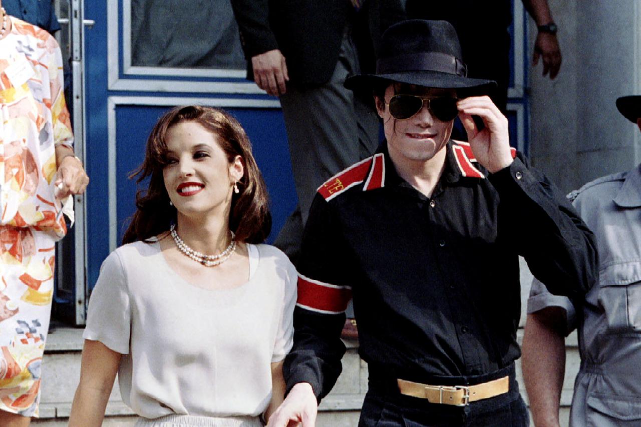 FILE PHOTO: Popstar Michael Jackson and his bride Lisa Marie Presley-Jackson hold each others hands in Budapest