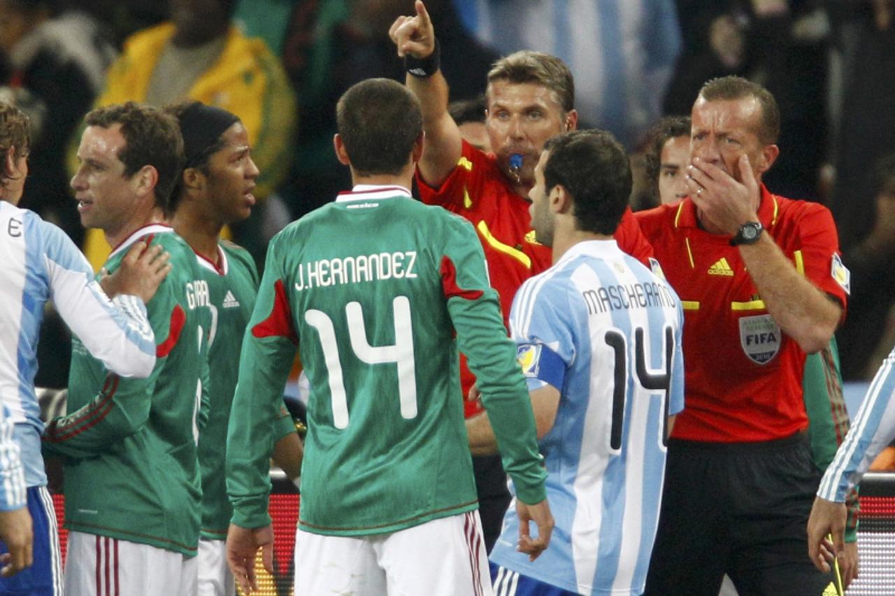 'Referee Roberto Rosetti of Italy gestures as Mexico players appeal for offside after a Carlos Tevez during the 2010 World Cup second round soccer match against Argentina at Soccer City stadium in Joh