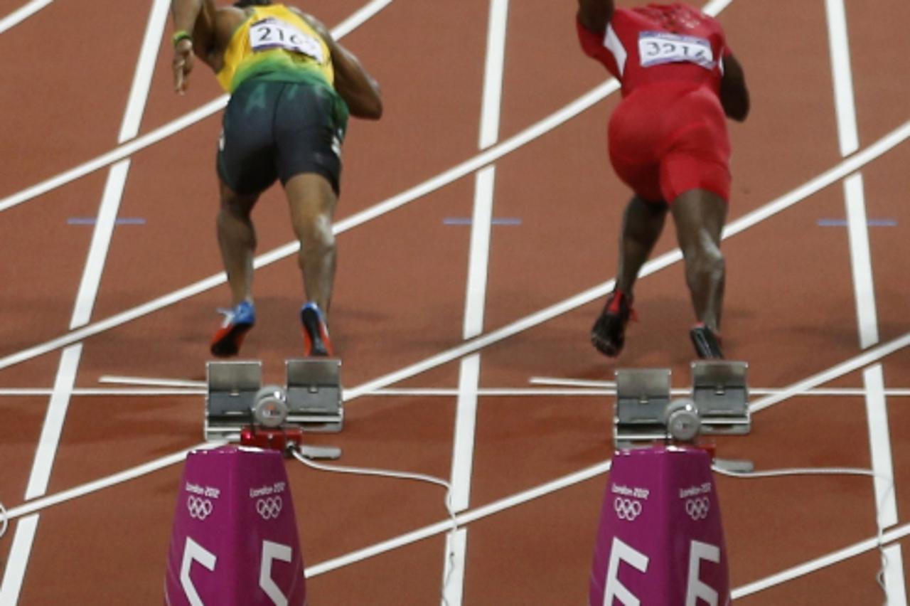 'A beer bottle bounces on the track as Yohan Blake (L) of Jamaica and Justin Gatlin of the US, competitors in the men\'s 100 metres final, start off the blocks at the London 2012 Olympic Games August 