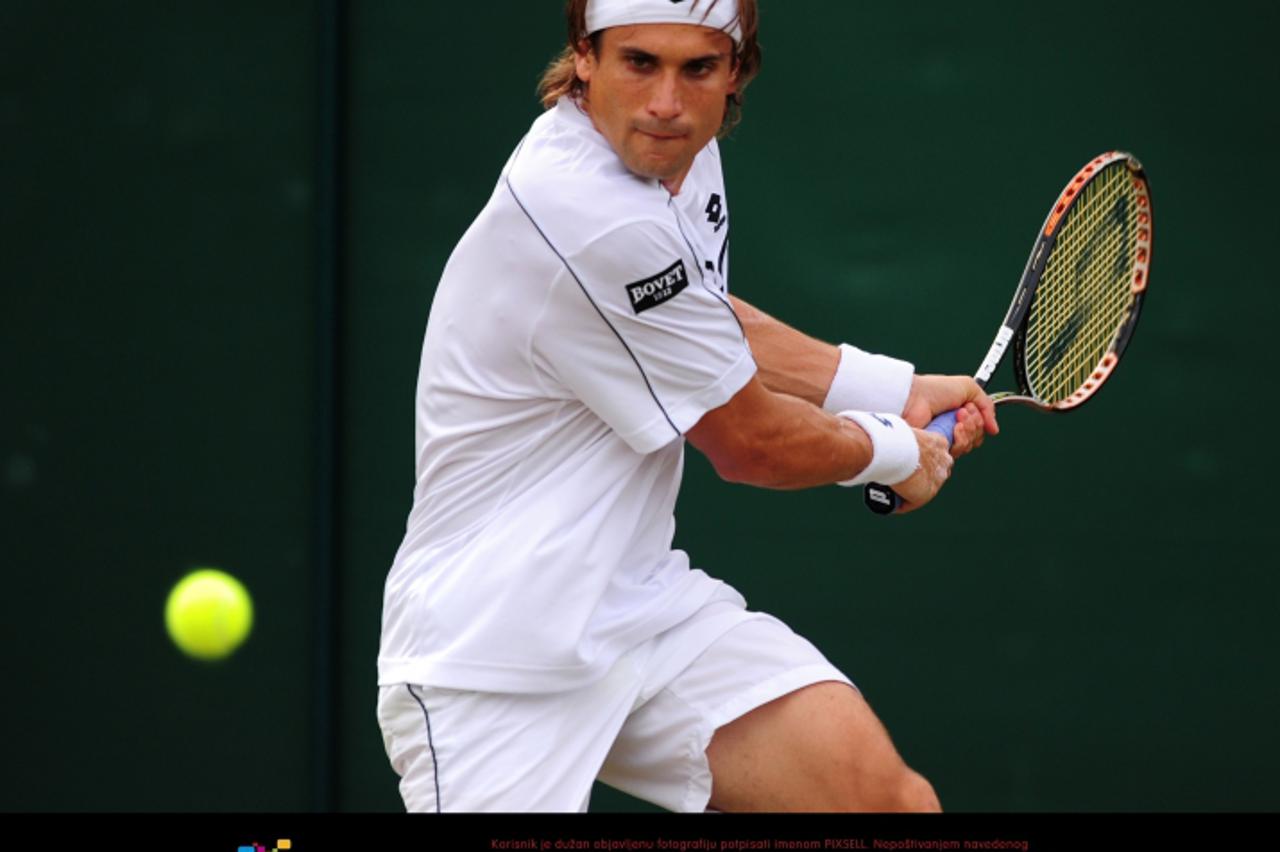 'Spain\'s David Ferrer in action during his match against France\'s Jo Wilfred Tsonga on day seven of the 2011 Wimbledon Championships at the All England Lawn Tennis and Croquet Club, Wimbledon. Photo