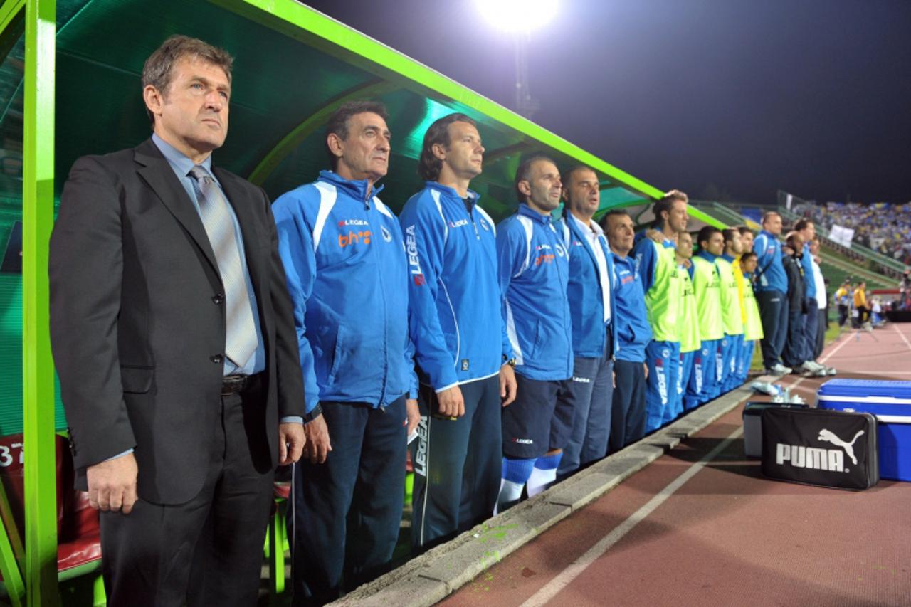 'Bosnia\'s national football team head Coach, Safet Susic (L), staff members and players stand during the national anthem before the Euro 2012 qualifying match Bosnia-Herzegovina vs. France at the Kos