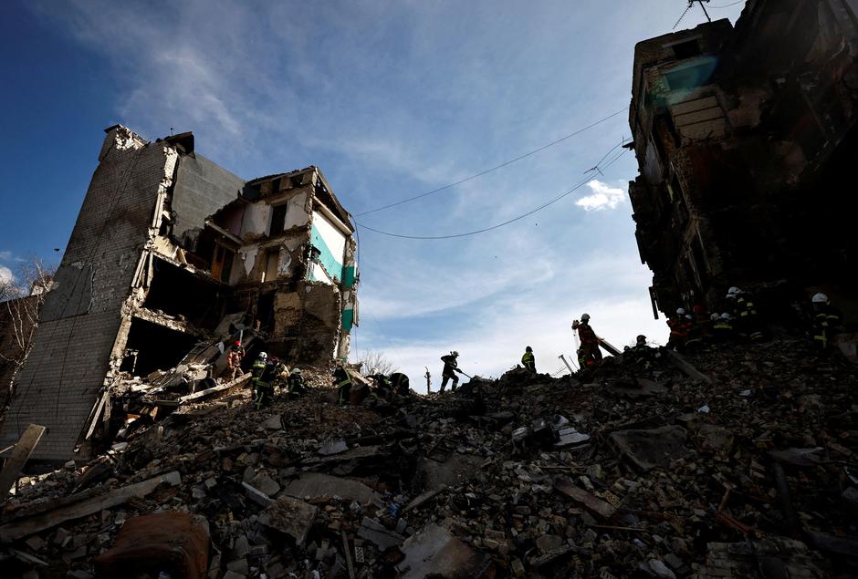 Rescuers work among remains of residential building destroyed by Russian shelling, amid Russia's invasion of Ukraine, in Borodyanka