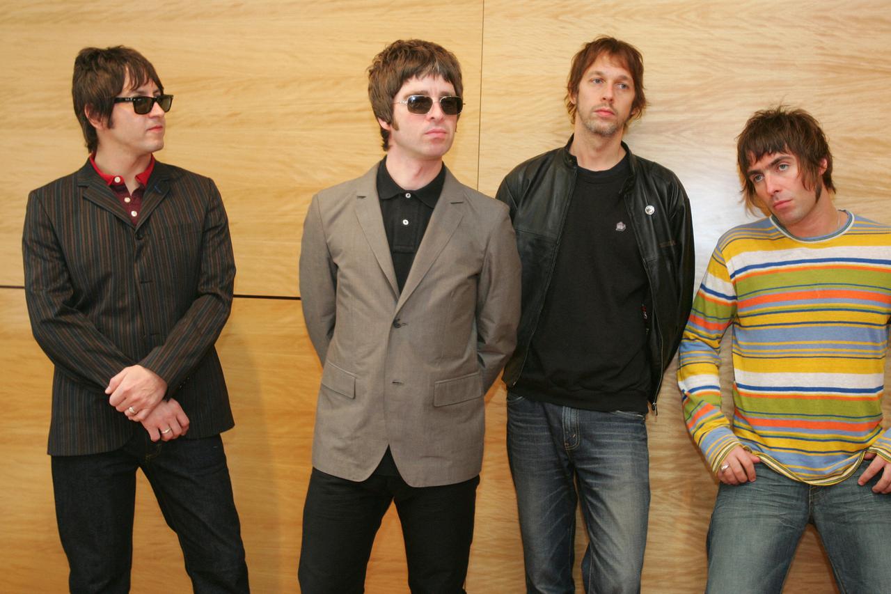 FILE PHOTO: Members of British rock band Oasis pose at news conference in Hong Kong