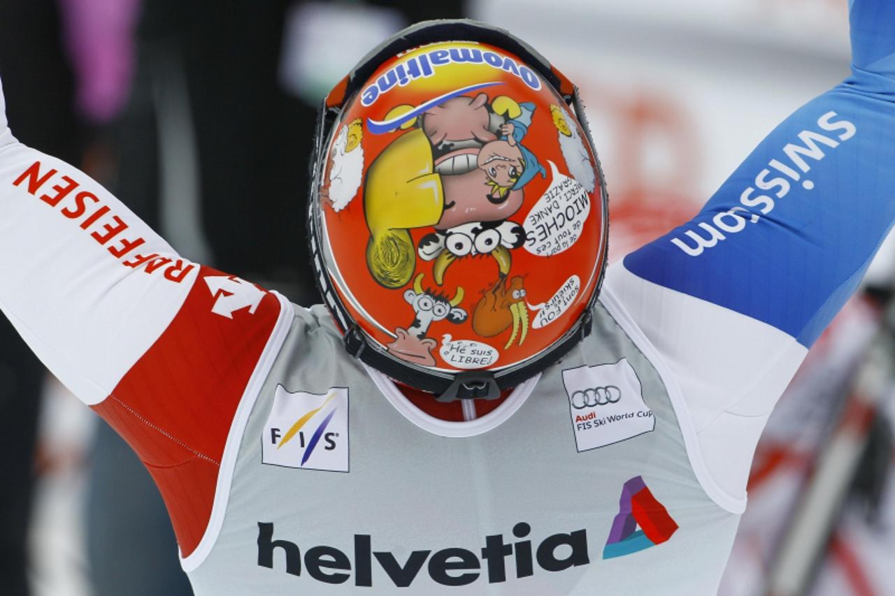 \'Didier Cuche of Switzerland celebrates in the finish area of the men\'s Downhill race at the Alpine Skiing World Cup Finals after winning the Downhill World Cup trophy in Lenzerheide March 16, 2011.