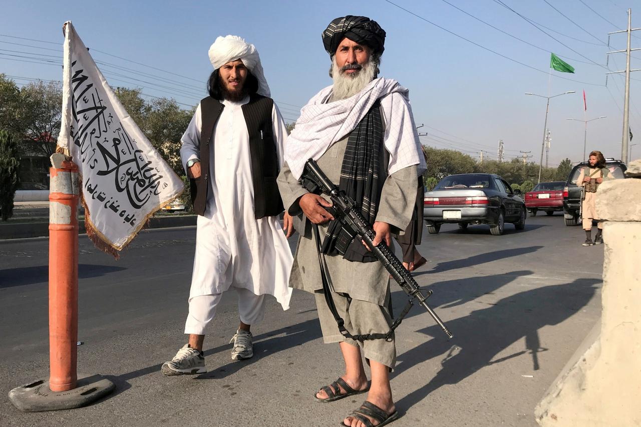 FILE PHOTO: Taliban fighter stand outside the Interior Ministry in Kabul