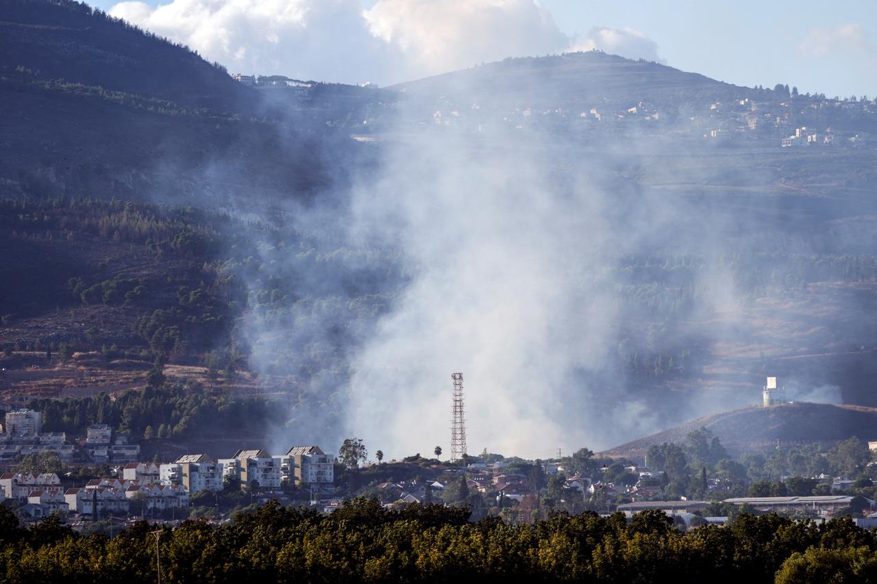 Smoke rises above Kiryat Shmona after rockets were fired from Lebanon towards Israel, amid cross-border hostilities between Hezbollah and Israel, as seen from northern Israel