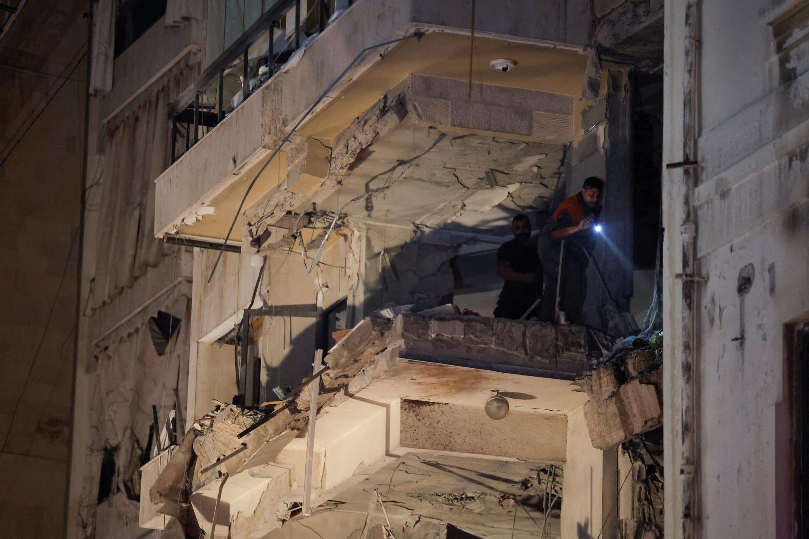 A person uses light to inspect inside a damaged building at the site of an Israeli air strike, amid ongoing hostilities between Hezbollah and Israeli forces, in Ras Al- Nabaa, in Beirut, Lebanon, October 10, 2024. REUTERS/Louisa Gouliamaki Photo: LOUISA GOULIAMAKI/REUTERS