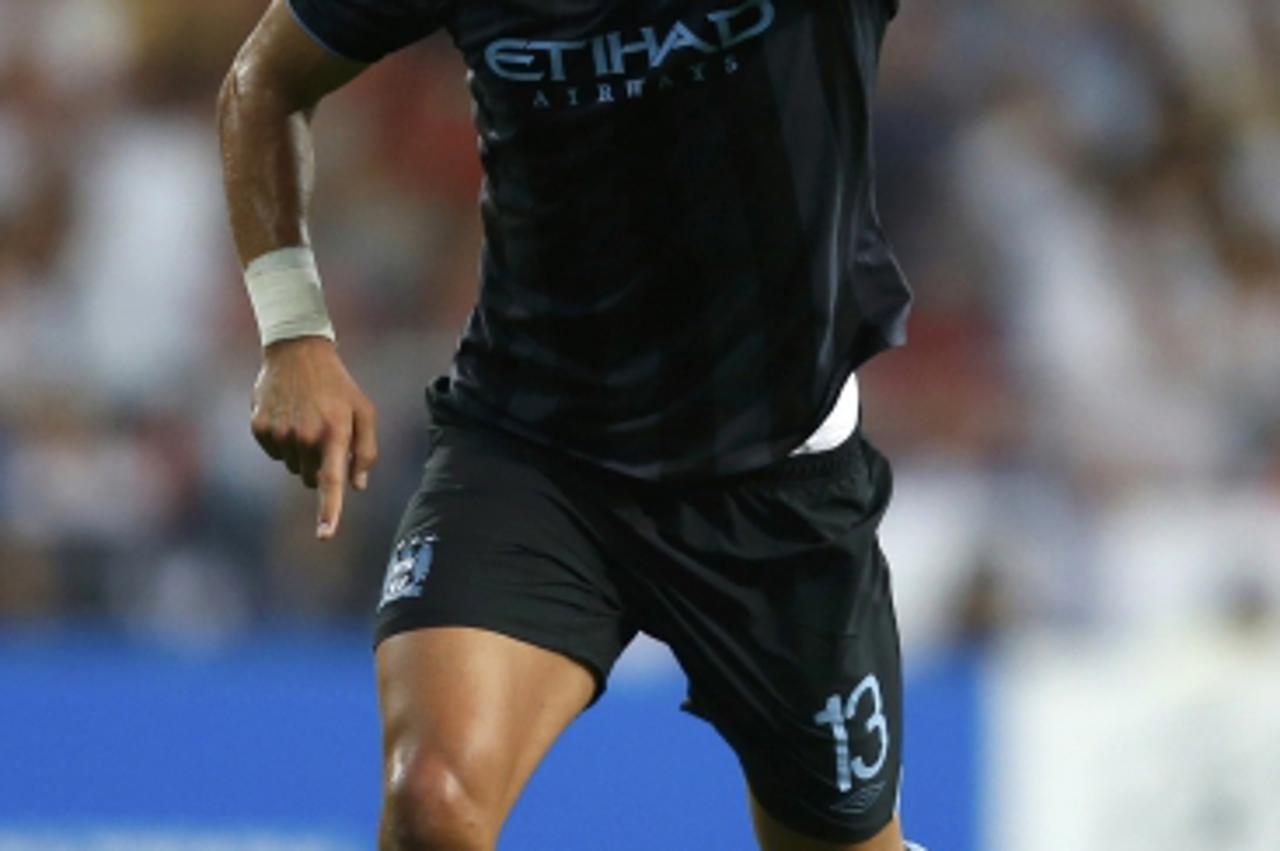 'Manchester City\'s Aleksandar Kolarov celebrates after scoring his team\'s second goal against Real Madrid during their Champions League Group D soccer match at the Santiago Bernabeu stadium in Madri