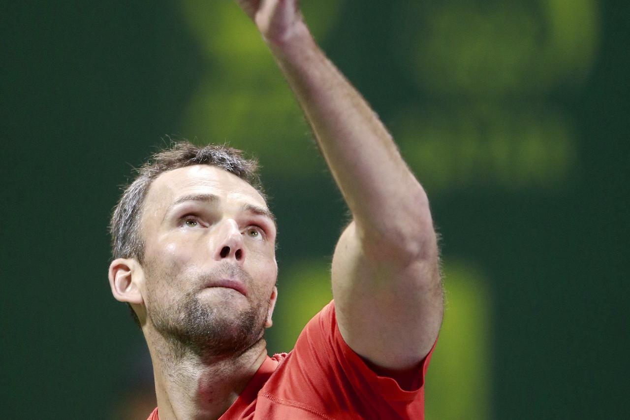 Croatia's Ivo Karlovic serves to Novak Djokovic of Serbia during their quarterfinal match at the Qatar Open tennis tournament in Doha January 8, 2015.  REUTERS/Mohammed Dabbous (QATAR - Tags: SPORT TENNIS)