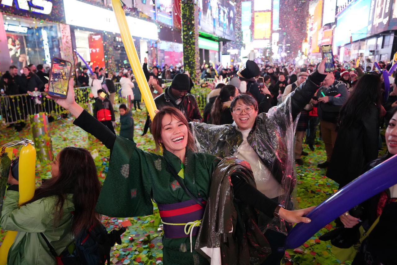 People react at Times Square during New Year's celebrations in New York City