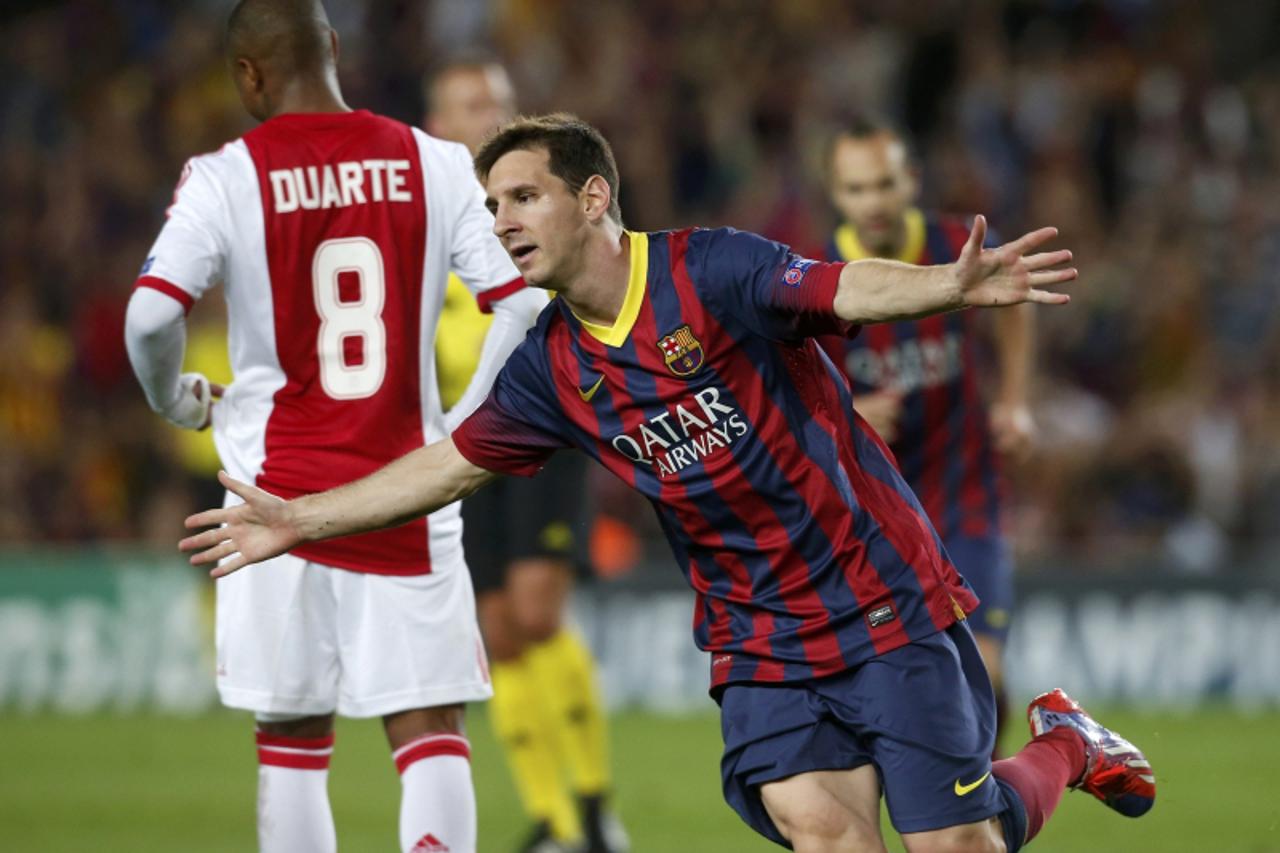 'Barcelona's Lionel Messi celebrates scoring a goal against Ajax during their Champions League soccer match at Camp Nou stadium in Barcelona September 18, 2013.    REUTERS/Albert Gea (SPAIN  - Tags: 