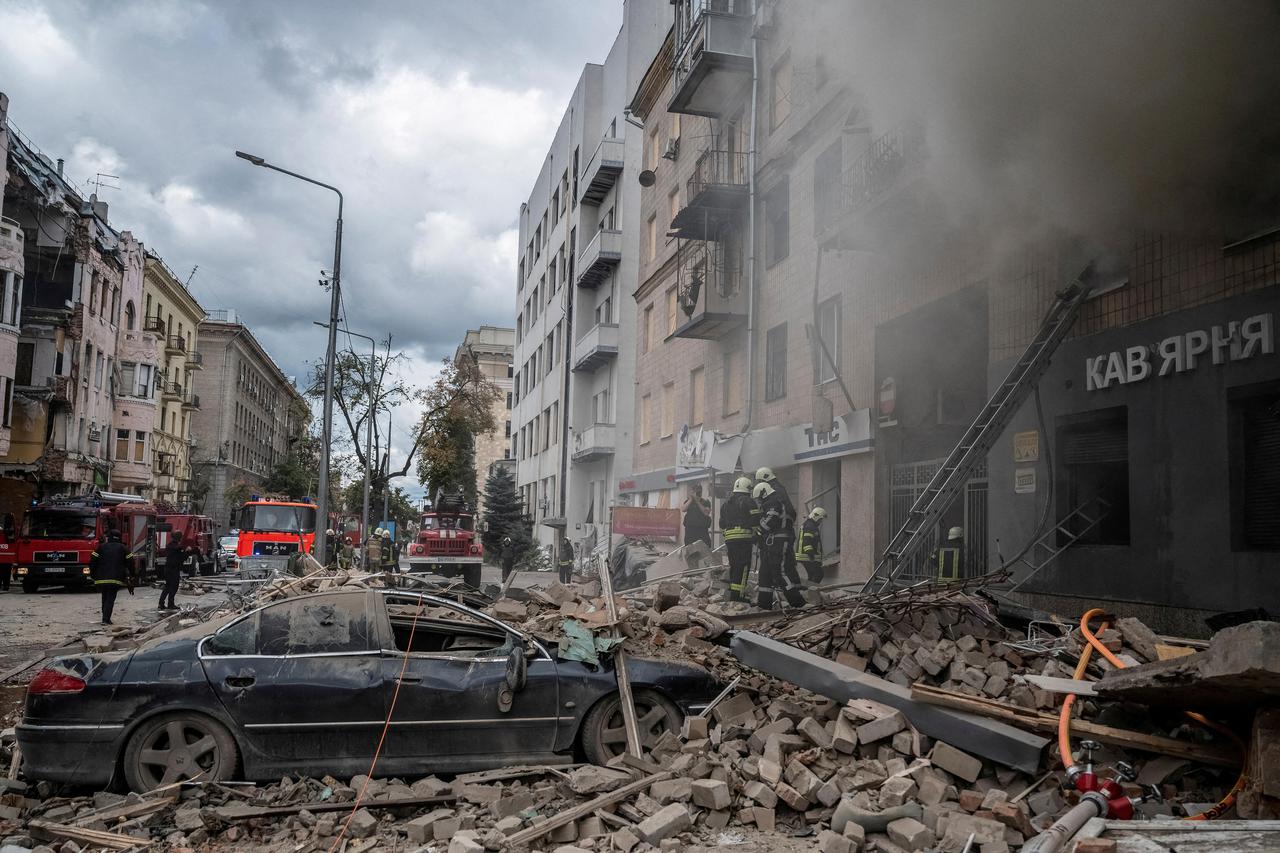 FILE PHOTO: Firefighters work at the site of a residential building hit by a Russian military strike in Kharkiv