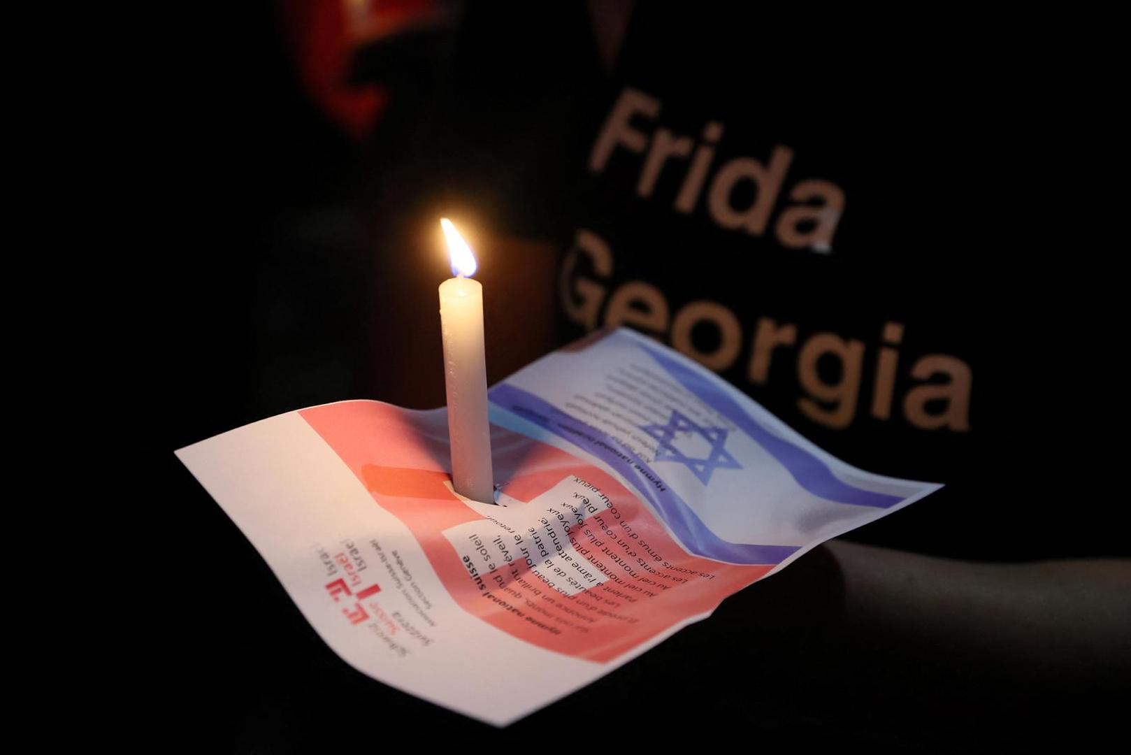 A demonstrator holds a candle during a demonstration organised by the Switzerland-Israel Association against the attacks by Hamas, outside the United Nations in Geneva, Switzerland, October 11, 2023. REUTERS/Denis Balibouse Photo: DENIS BALIBOUSE/REUTERS