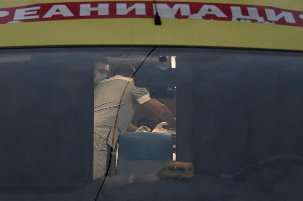 An ambulance transporting Russian opposition leader Alexei Navalny drives out of a hospital in Omsk