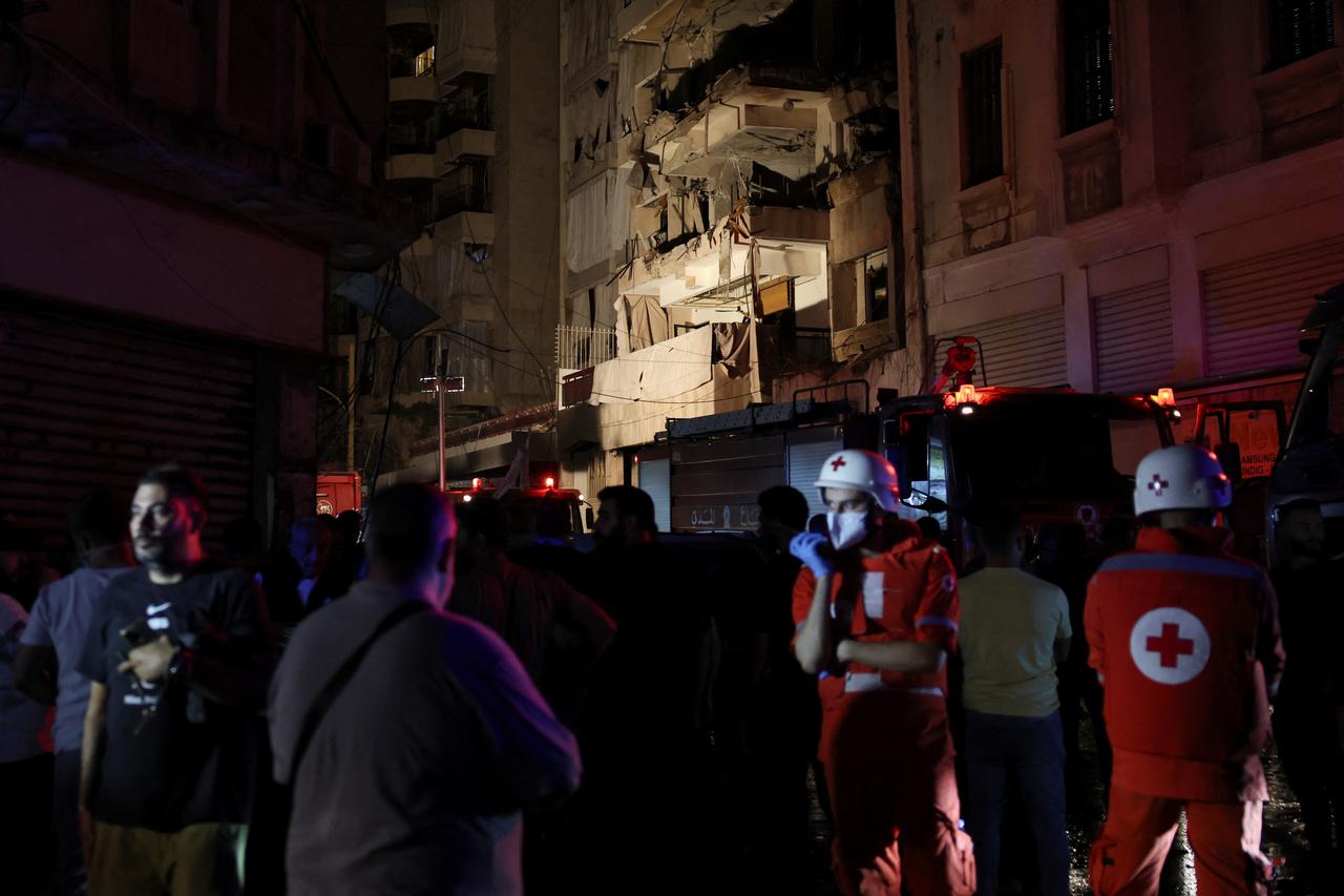 Rescue vehicles attend to the site of an Israeli air strike, in Beirut