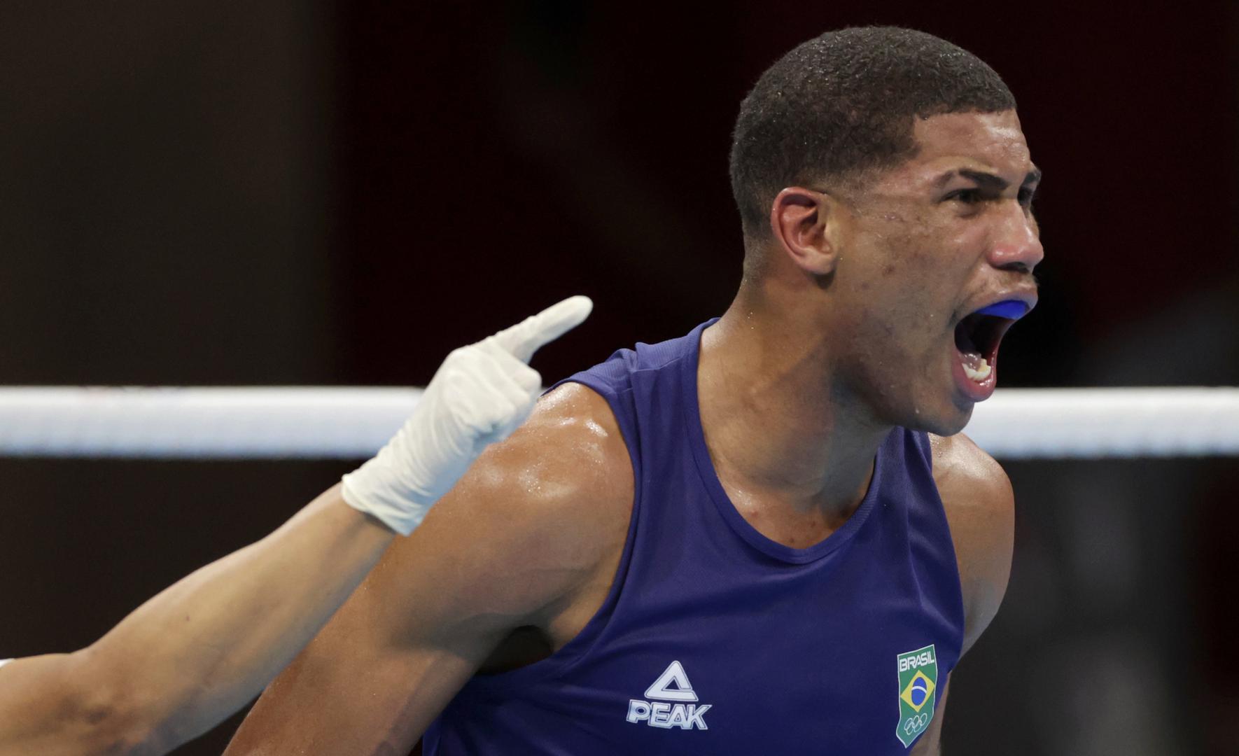 Boxing - Men's Middleweight - Final Tokyo 2020 Olympics - Boxing - Men's Middleweight - Final - Kokugikan Arena - Tokyo, Japan - August 7, 2021. Hebert Sousa of Brazil reacts after knocking down Oleksandr Khyzhniak of Ukraine during their final fight. REUTERS/Ueslei Marcelino UESLEI MARCELINO