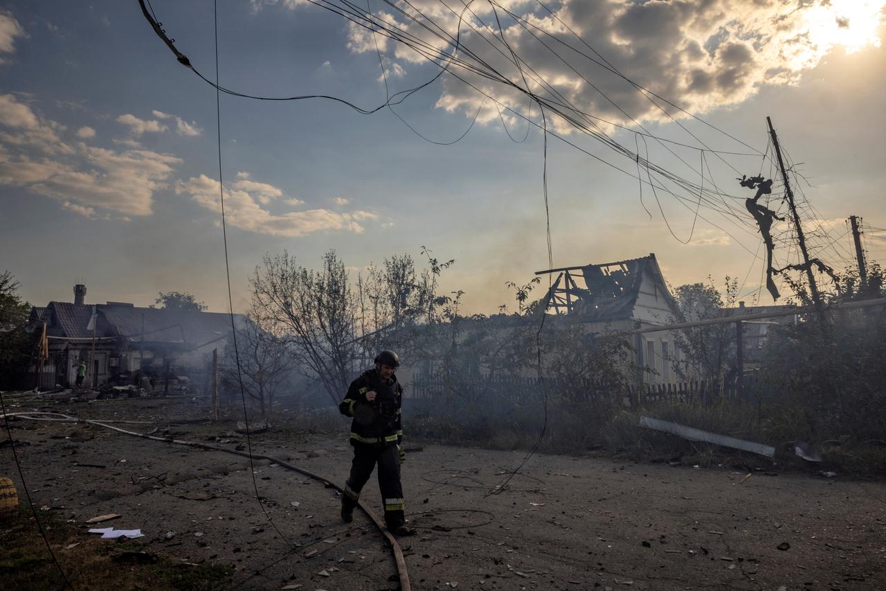 An emergency worker walks past a house that was destroyed after a Russian strike on a residential area in Pokrovsk