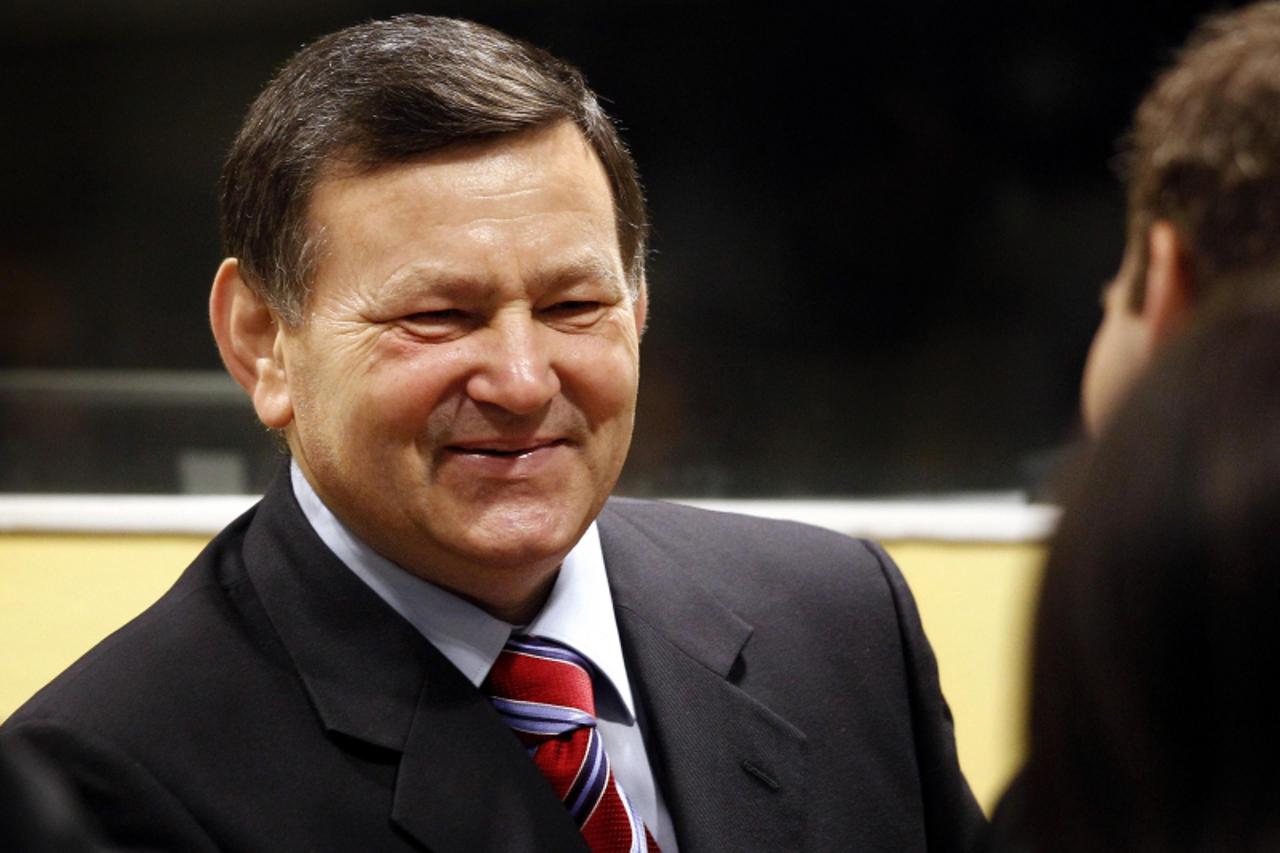 'Mladen Markac, a former Croatian police commander, smiles as he talks to his lawyer in the courtroom of the International Criminal Tribunal for the former Yugoslavia (ICTY) before his appeal judgemen