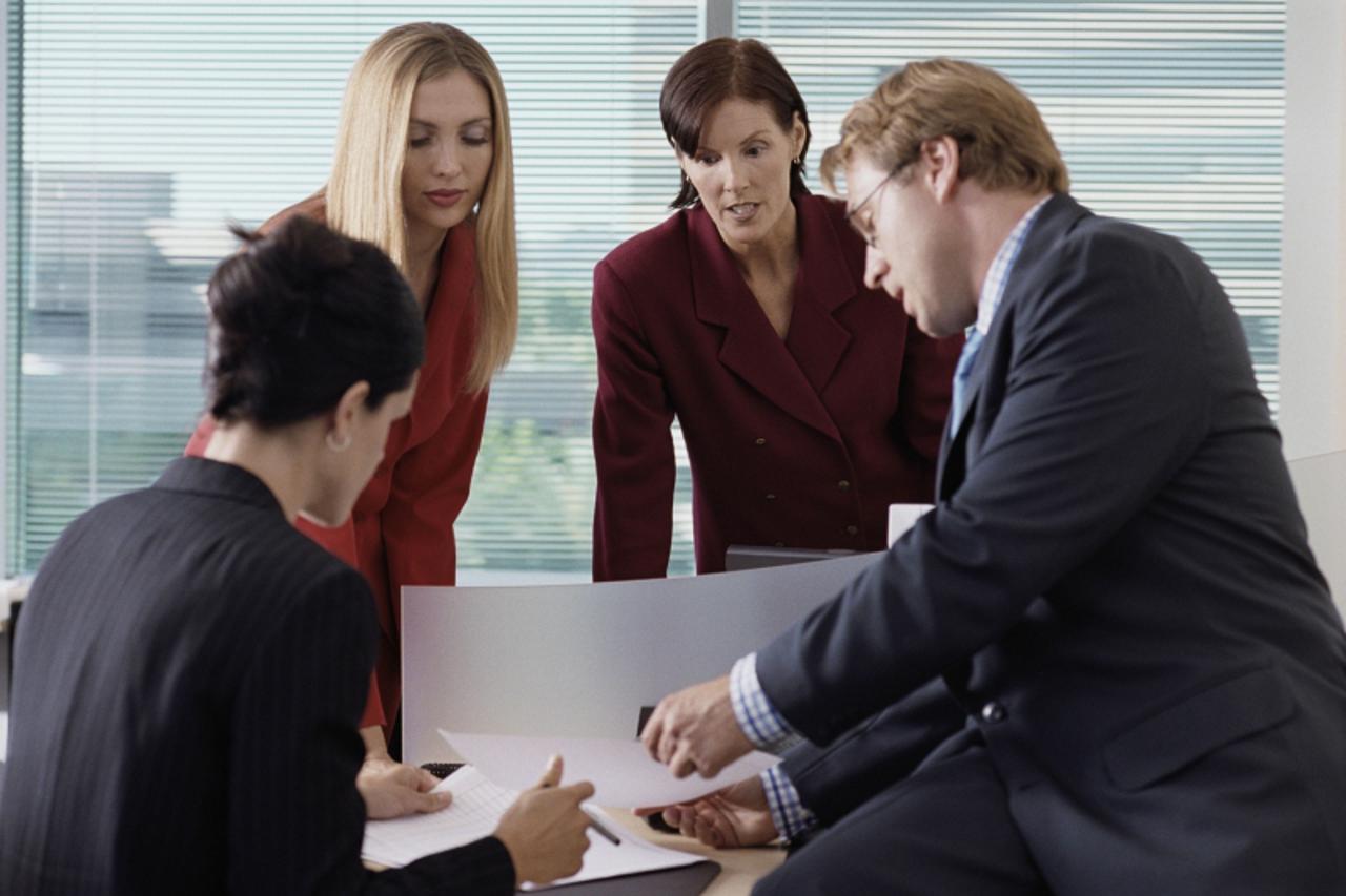 'Business colleagues talking indoors'