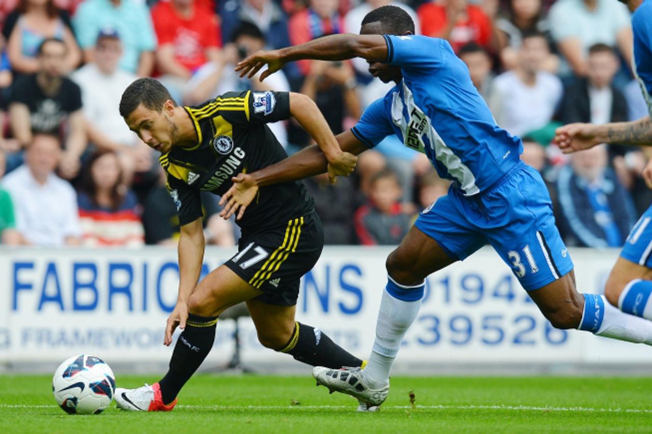 'Chelsea\'s Belgian midfielder Eden Hazard (L) vies for the ball with Wigan Athletic\'s Honduran defender Maynor Figueroa (C) leading to a penalty during their English Premier League football match at